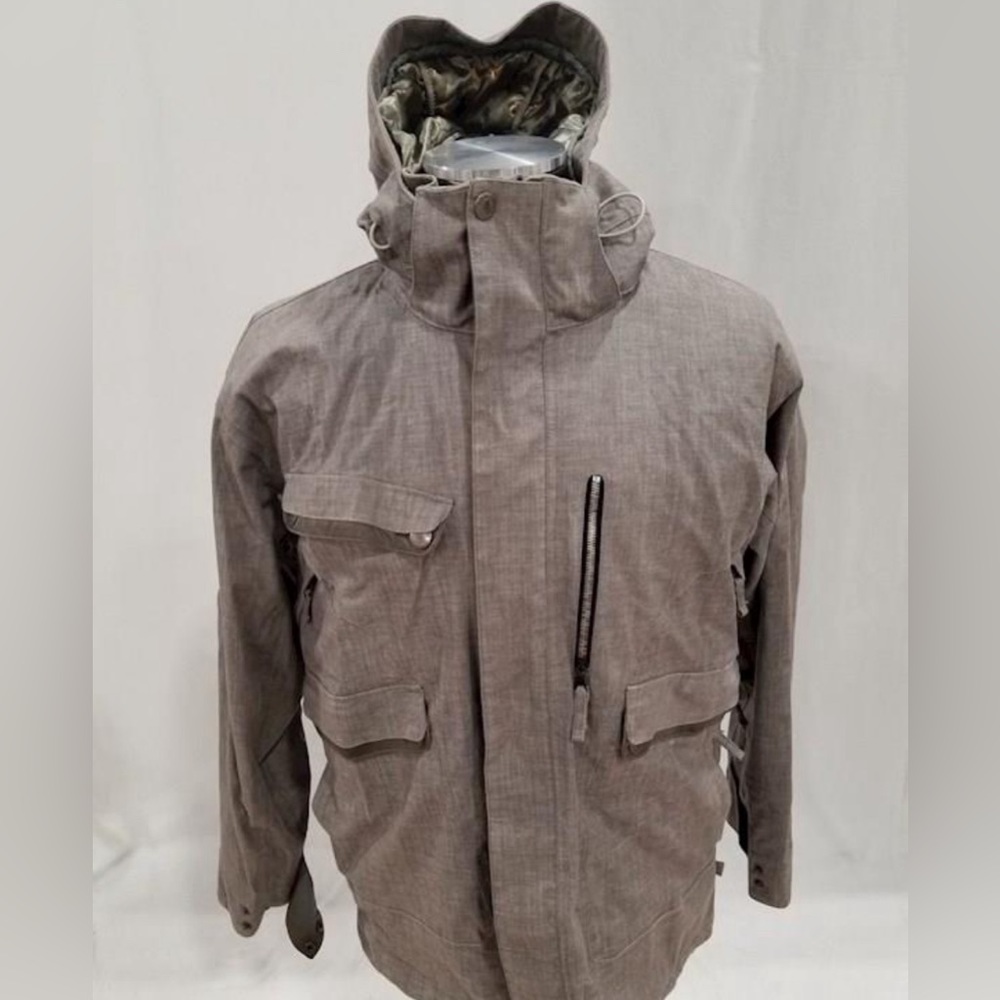Men’s large waterproof jacket. Brown/tan color. Has taped seams. Had a hood.